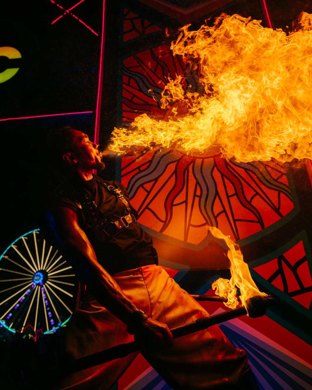 Fire performer in front of a stage installation at EDC Thailand